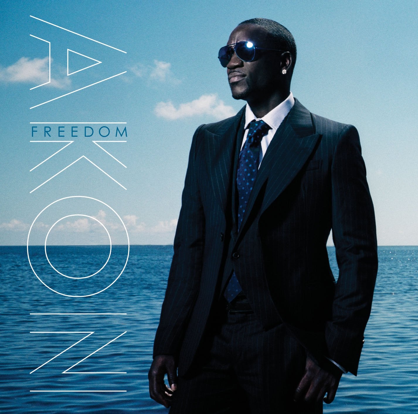 Audio CD cover for Akon's album 'Freedom' featuring a close-up portrait of Akon with a blue sky and ocean background.