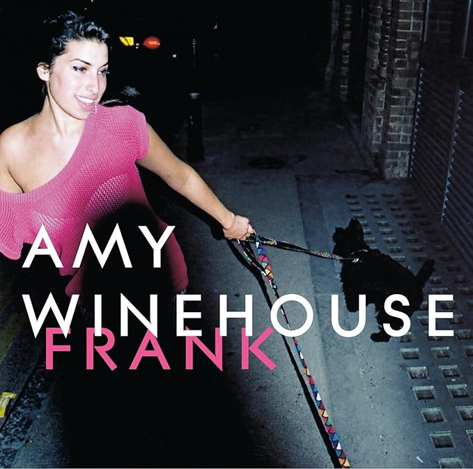 Amy Winehouse album cover featuring a black and white image of the artist with a dog on a leash.