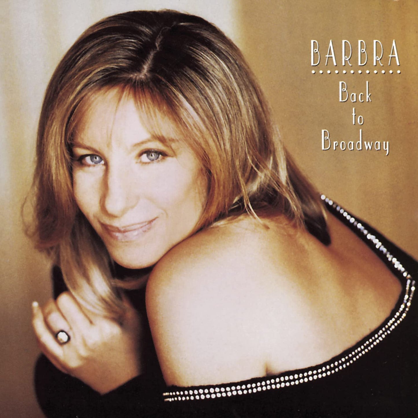 The cover image features a woman with light brown hair and a smile on her face, dressed in a black top. She has her left arm curled around the lower part of her body, and she is wearing a ring on the finger visible in the image.