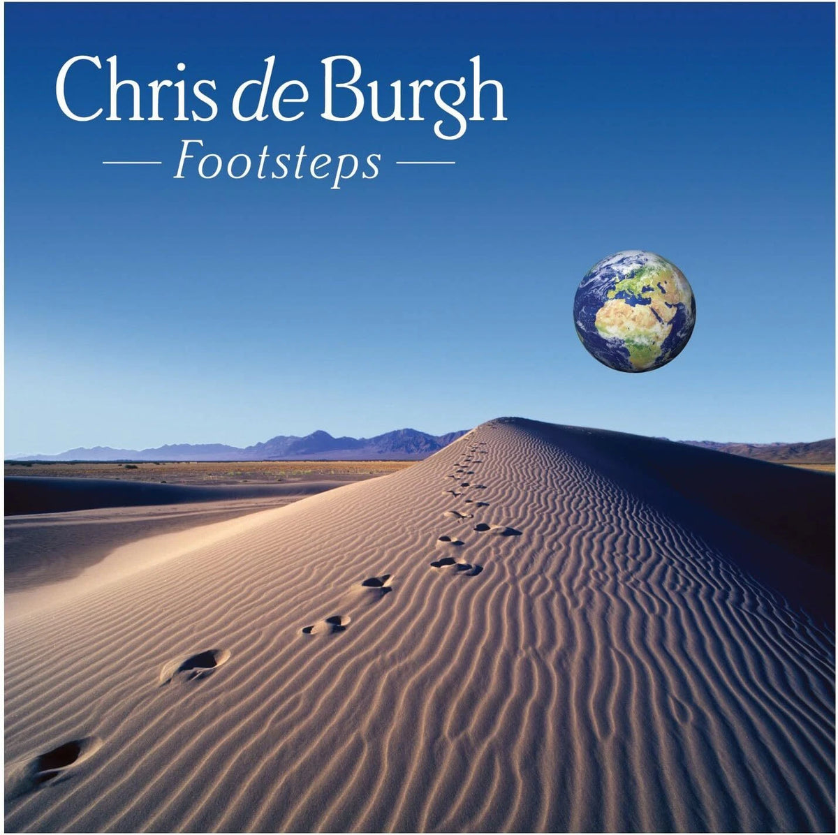 Album cover for Chris de Burgh's 'Footsteps', featuring a desert landscape with footprints leading up a sand dune toward distant mountains under a clear blue sky, with a floating Earth in the upper right. The artist's name and title are printed in white text at the top.