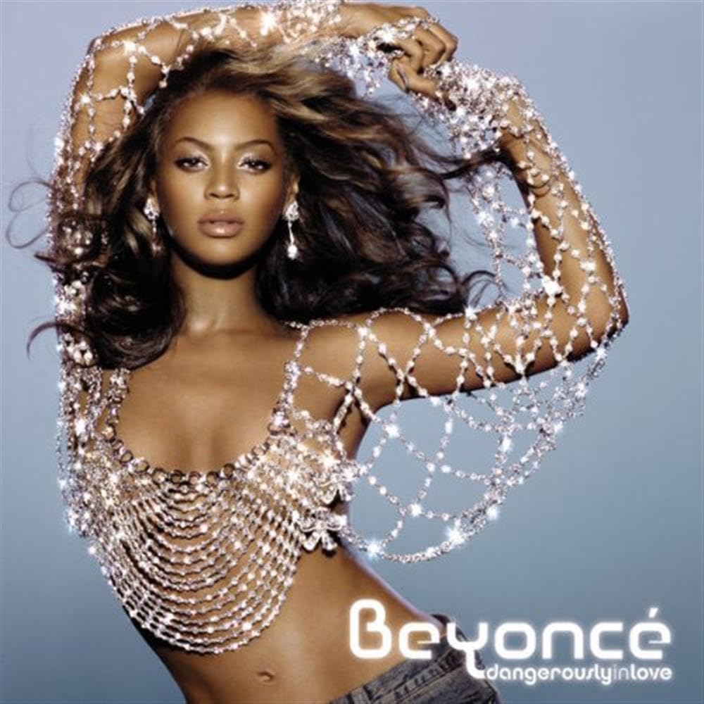 Beyoncé with sparkling chain outfit on a gray background