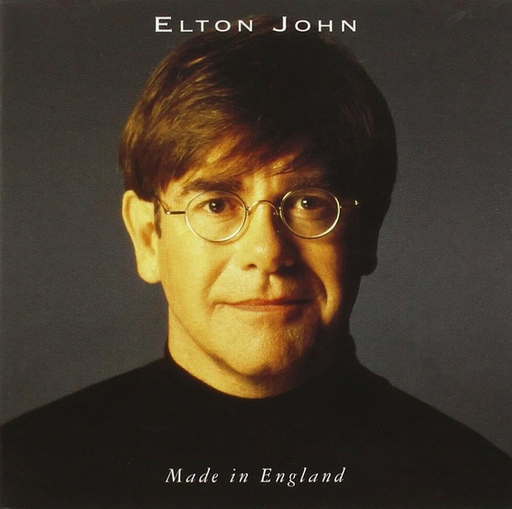 Album cover featuring a portrait of a person with text 'Elton John Made in England' on a dark background