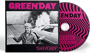 Audio CD cover of Green Day's 'Saviors' album featuring a black and pink design with the band's logo and album title.