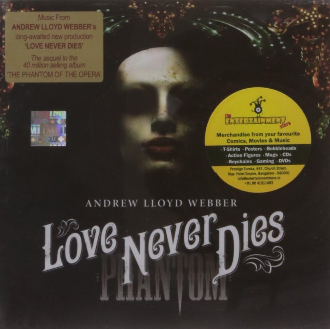 Vinyl record cover for 'Love Never Dies' by Andrew Lloyd Webber with a dark background and text.
