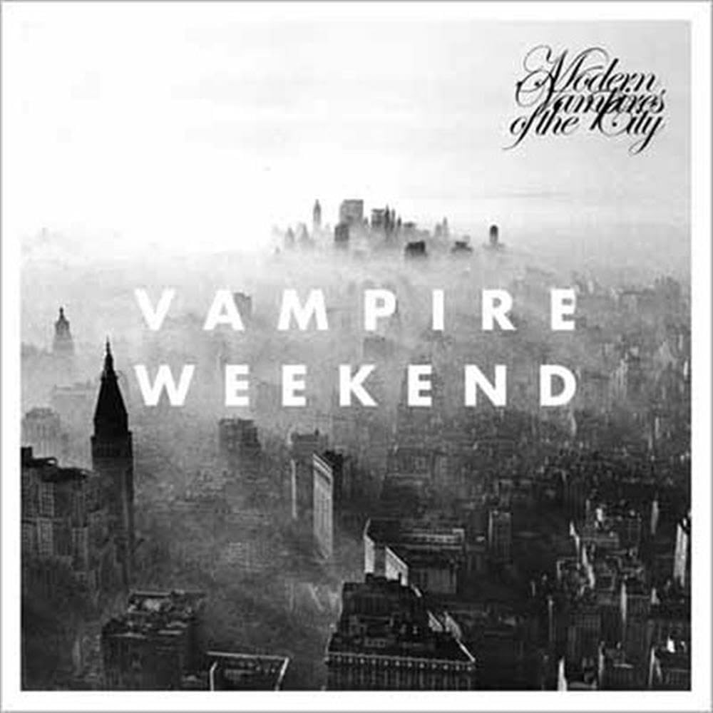 Album cover art for 'Vampire Weekend' featuring a black and white photograph of a city skyline shrouded in fog, with the band's name in script at the top right and the album title in large white letters across the center.