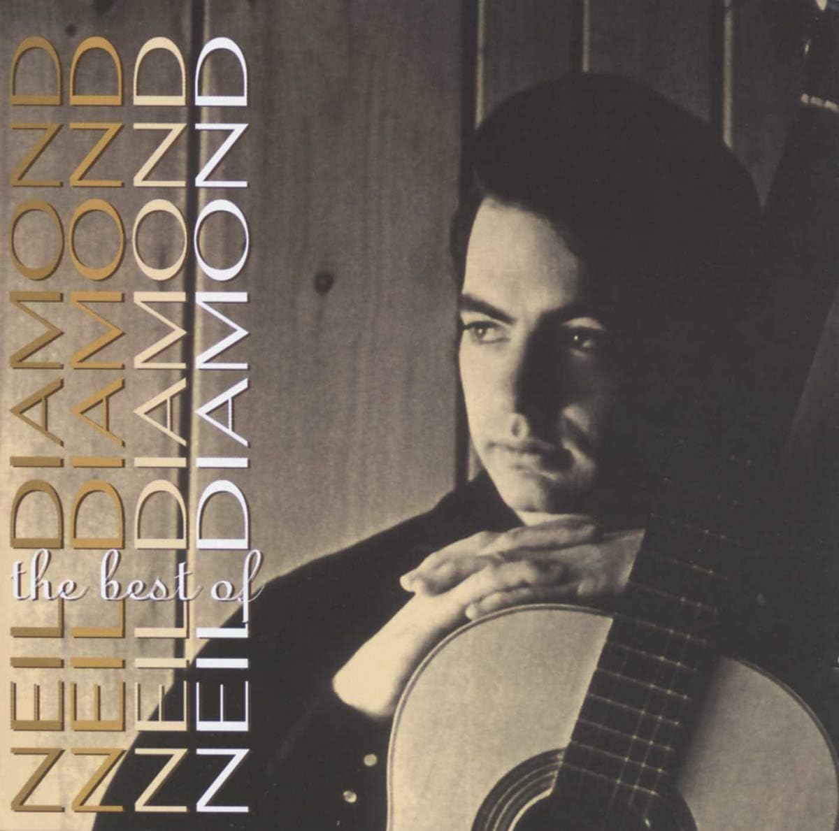 Album cover featuring a person holding a guitar with 'The Best of Neil Diamond' text.