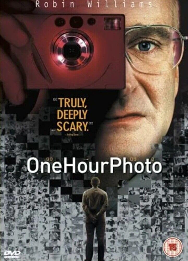 Movie poster for 'One Hour Photo' featuring a person with a camera and text.