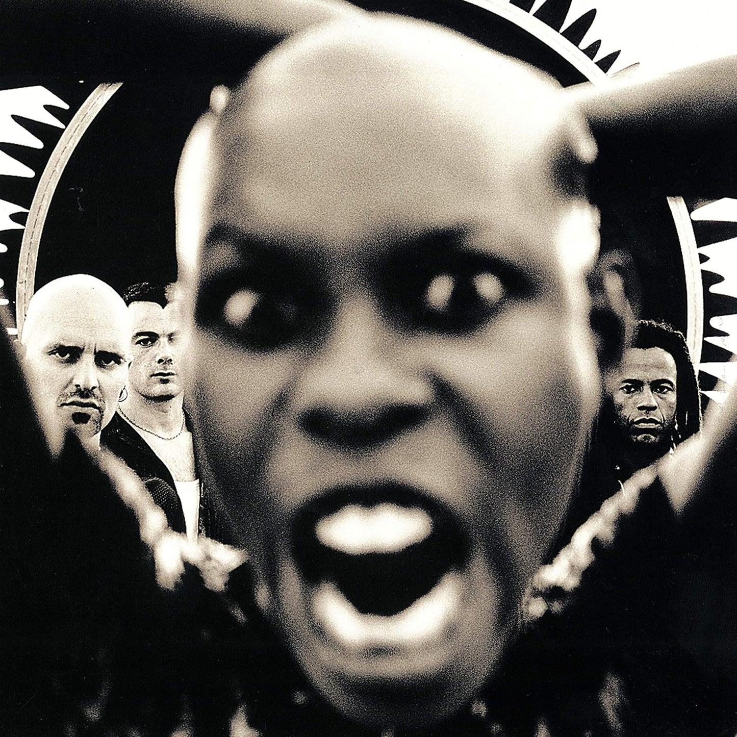 Black and white album cover with a person in the foreground and others in the background.