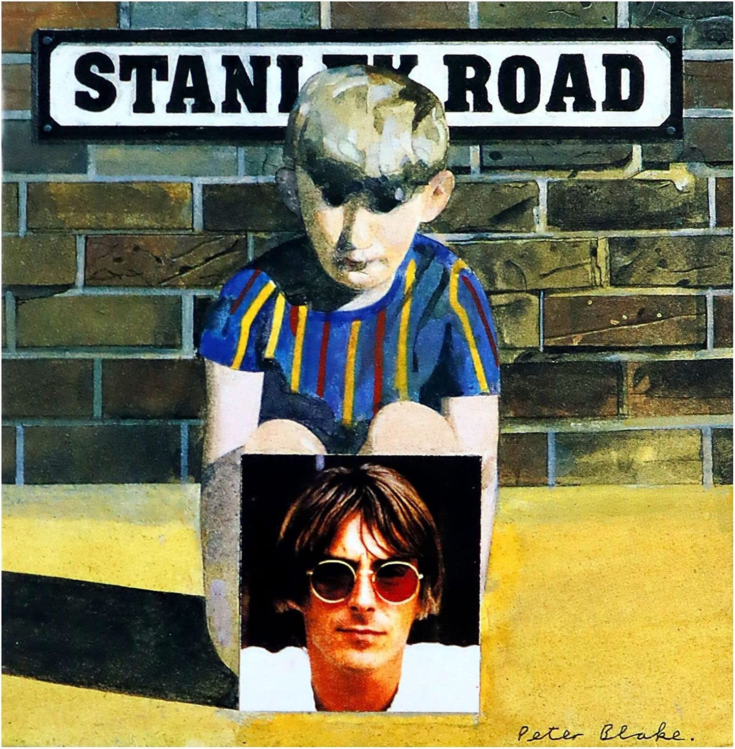 A CD cover featuring a painting of a young boy sitting on a wall with 'Stanley Road' sign in the background. The artist's name, Paul Weller, is visible at the bottom.