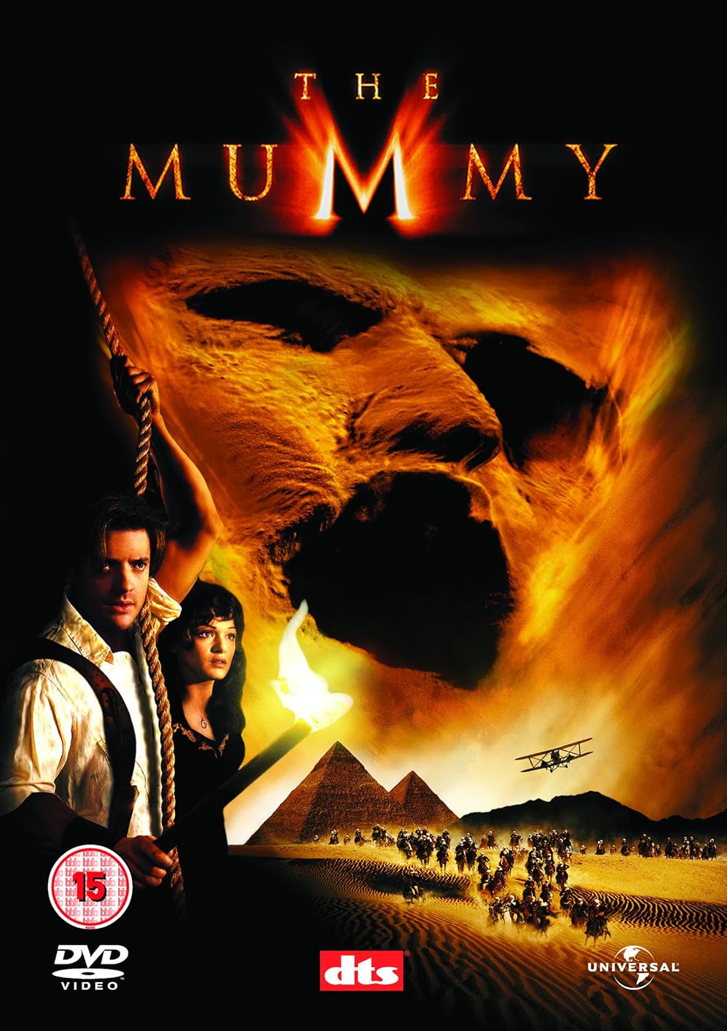 Movie poster for 'The Mummy' featuring a mummy's face and two people in front of pyramids.