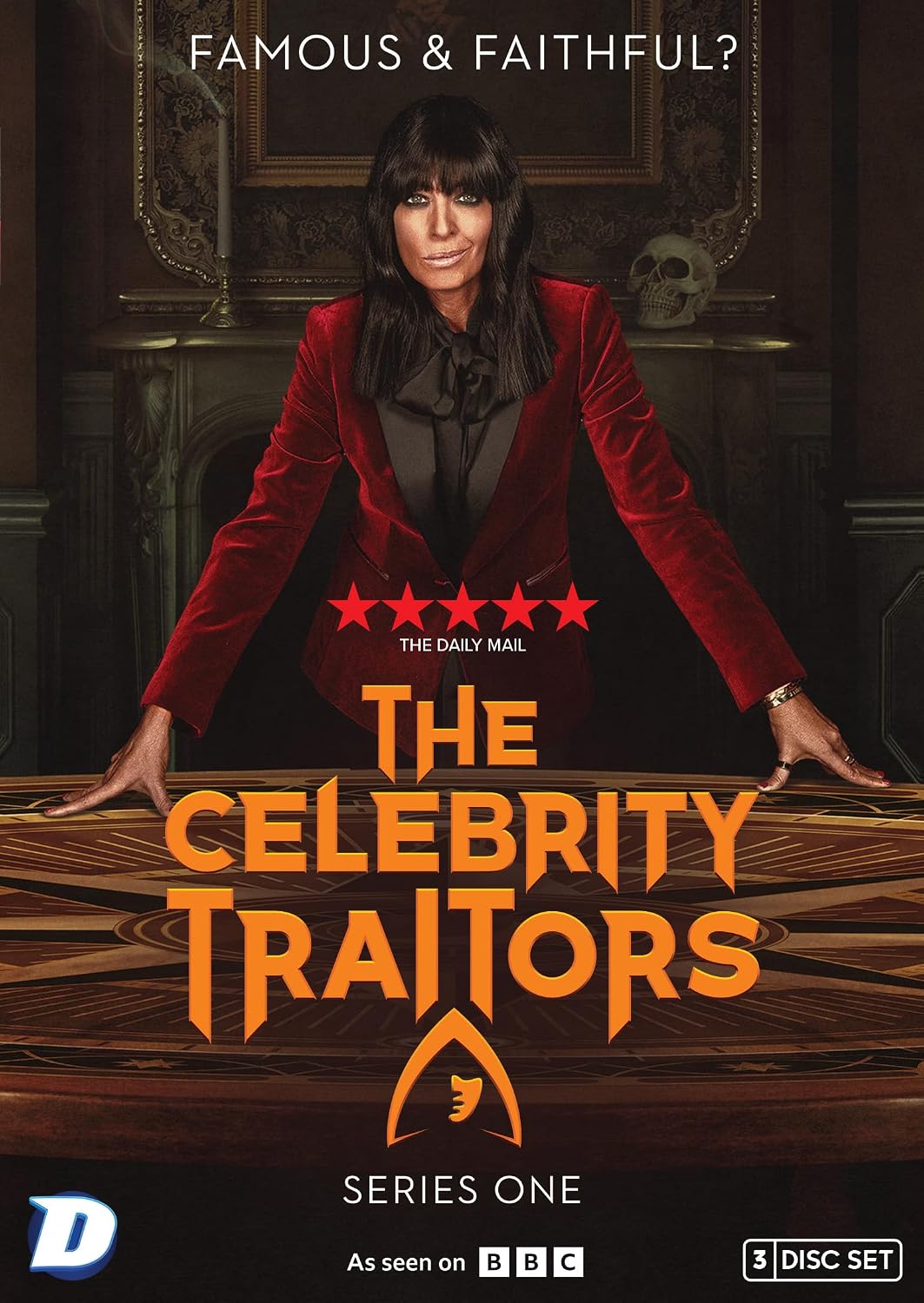 Front cover of 'The Celebrity Traitors Series One' 3-disc DVD box set, featuring a portrait of a woman in a red velvet blazer leaning over a table with the show's title in large orange text.