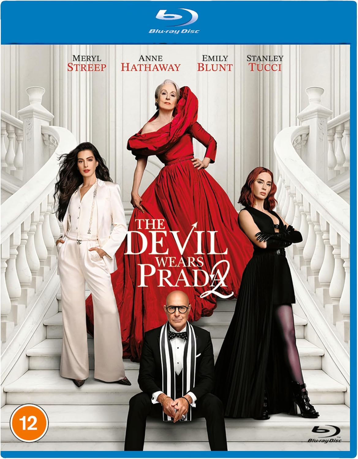 Blu-ray cover for The Devil Wears Prada, featuring Meryl Streep, Anne Hathaway, Emily Blunt, Stanley Tucci, and a man seated at the bottom, posed on white staircase steps. The cover has a blue border with Blu-ray Disc branding and a 12 age rating icon.