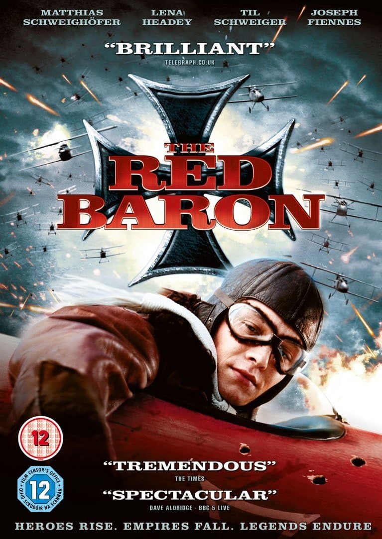 The movie poster for 'The Red Baron' featuring a vintage flying ace in a leather flight suit and goggles, set against a dramatic sky with biplanes and explosions. Large red and black title text is displayed in the center.