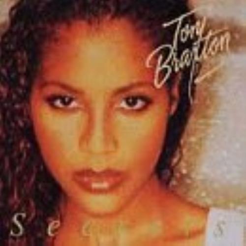Cover of the Toni Braxton album 'Secrets', featuring a close-up portrait of the artist.