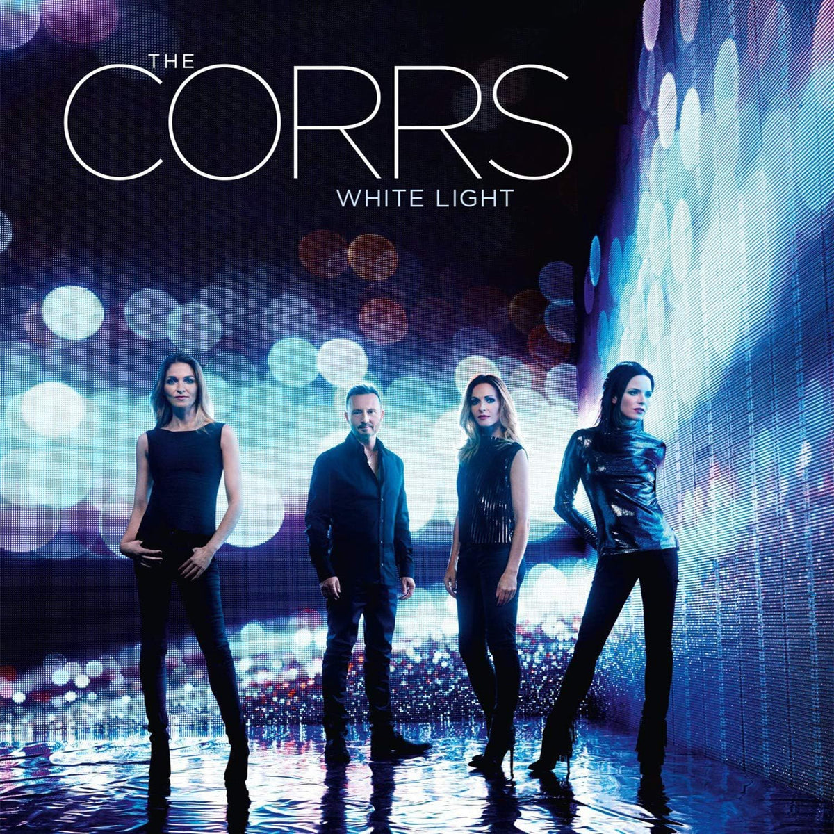 Album cover for 'White Light' by The Corrs featuring four band members against a vibrant, blurred light background.