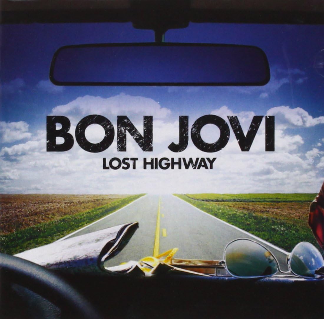 Album cover for Bon Jovi's 'Lost Highway', showing a view from inside a car looking out onto a straight road stretching into the horizon under a blue sky with clouds. Large black text reads 'BON JOVI' and 'LOST HIGHWAY'.
