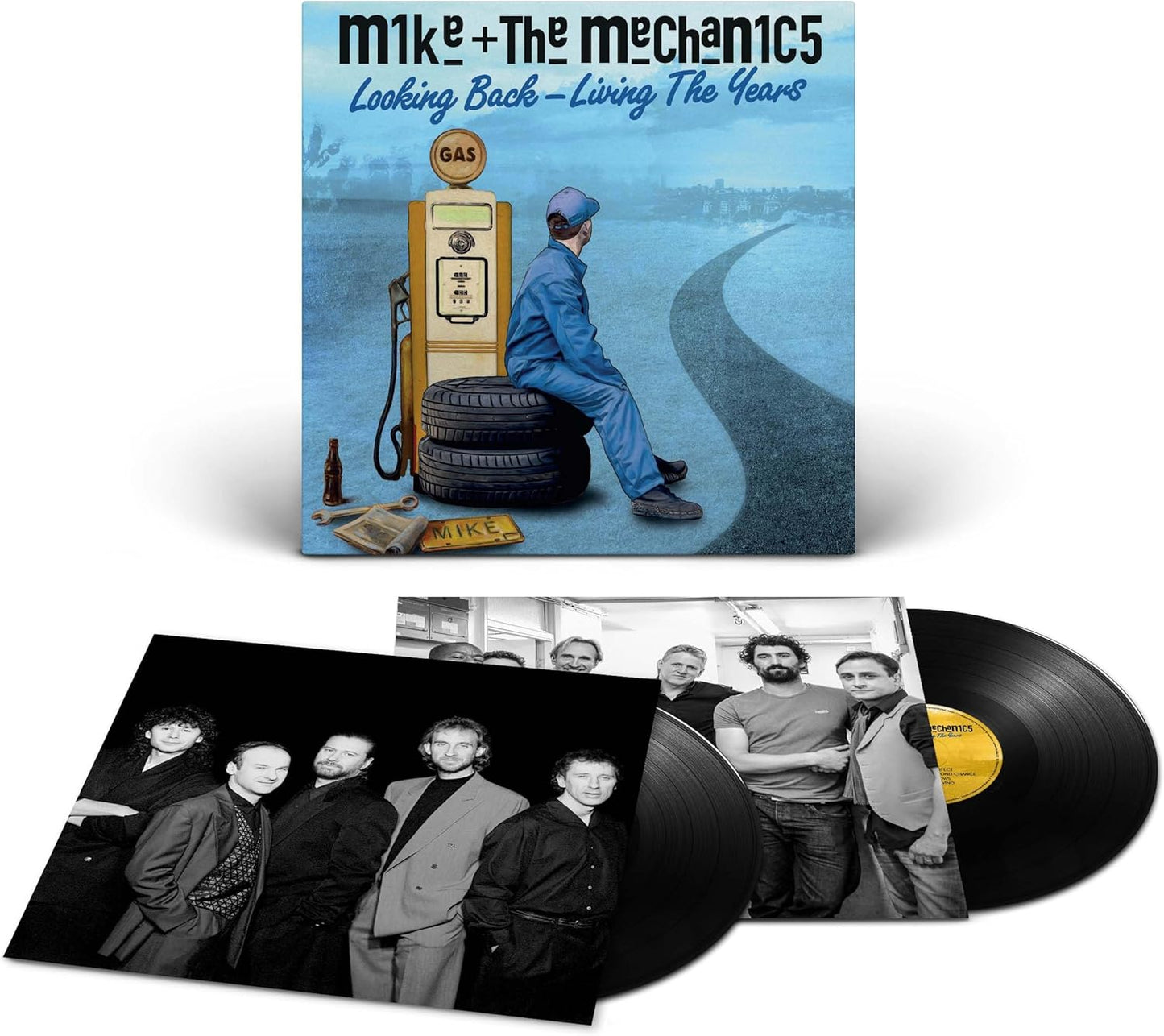 Vinyl record set with cover featuring a person sitting on a tire next to a gas pump.