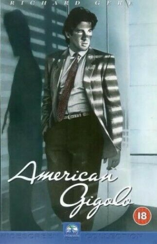 DVD cover for the movie 'American Gigolo' featuring a man in a suit with a reflective background.