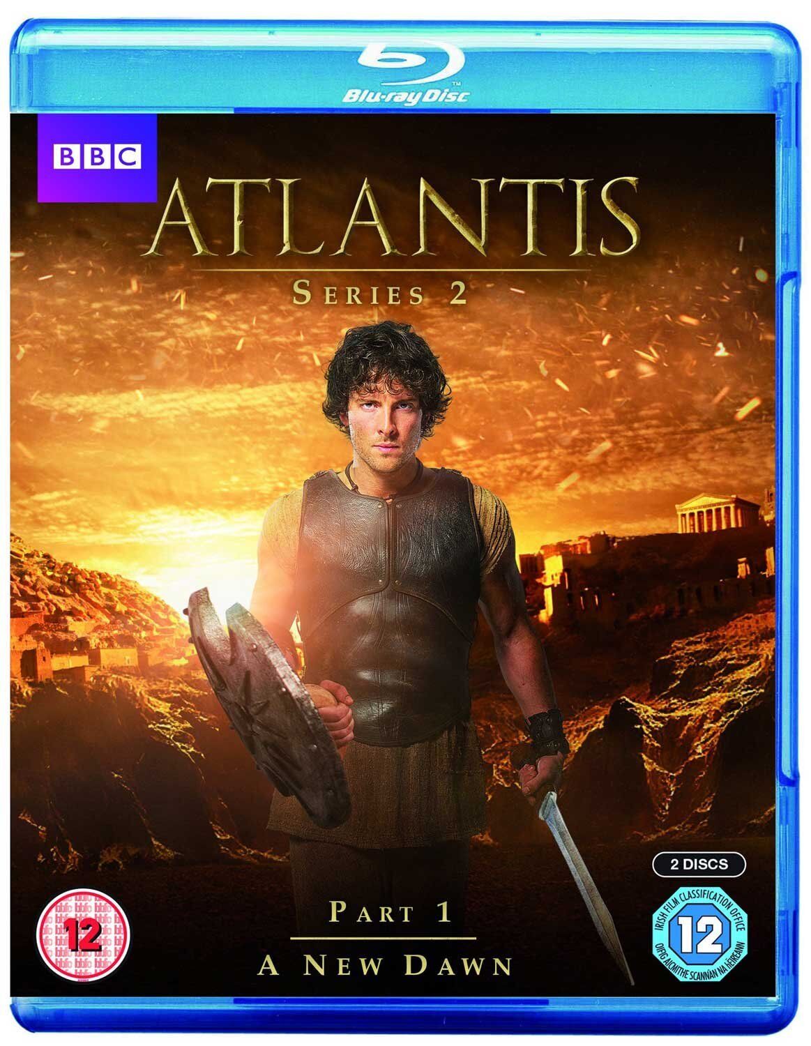 Blu-ray cover for 'Atlantis - Series 2 Part 1' featuring an image of a male character in ancient warrior costume with a sword, against a backdrop of a sunset with the Acropolis in the distance.