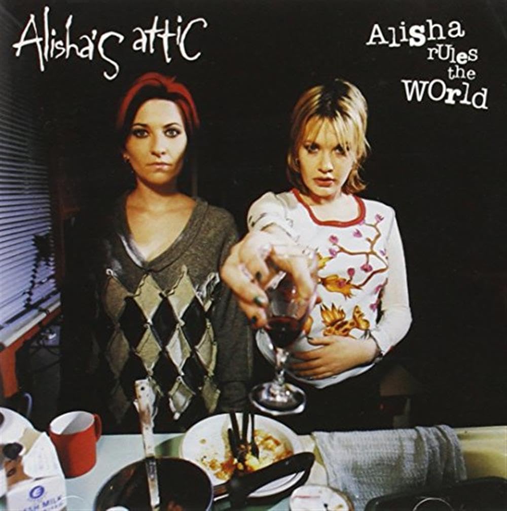 Two women at a table with a glass of wine, featuring 'Alisha's Attic' branding.