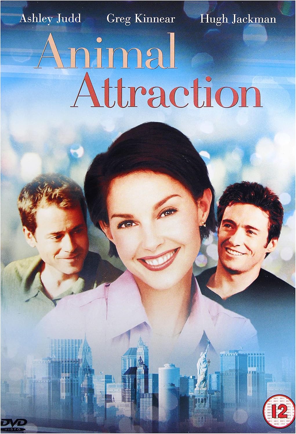 DVD cover for the movie 'Animal Attraction' featuring Ashley Judd, Greg Kinnear, and Hugh Jackman, with a blue-toned cityscape background and a 12 age rating badge in the bottom right corner.