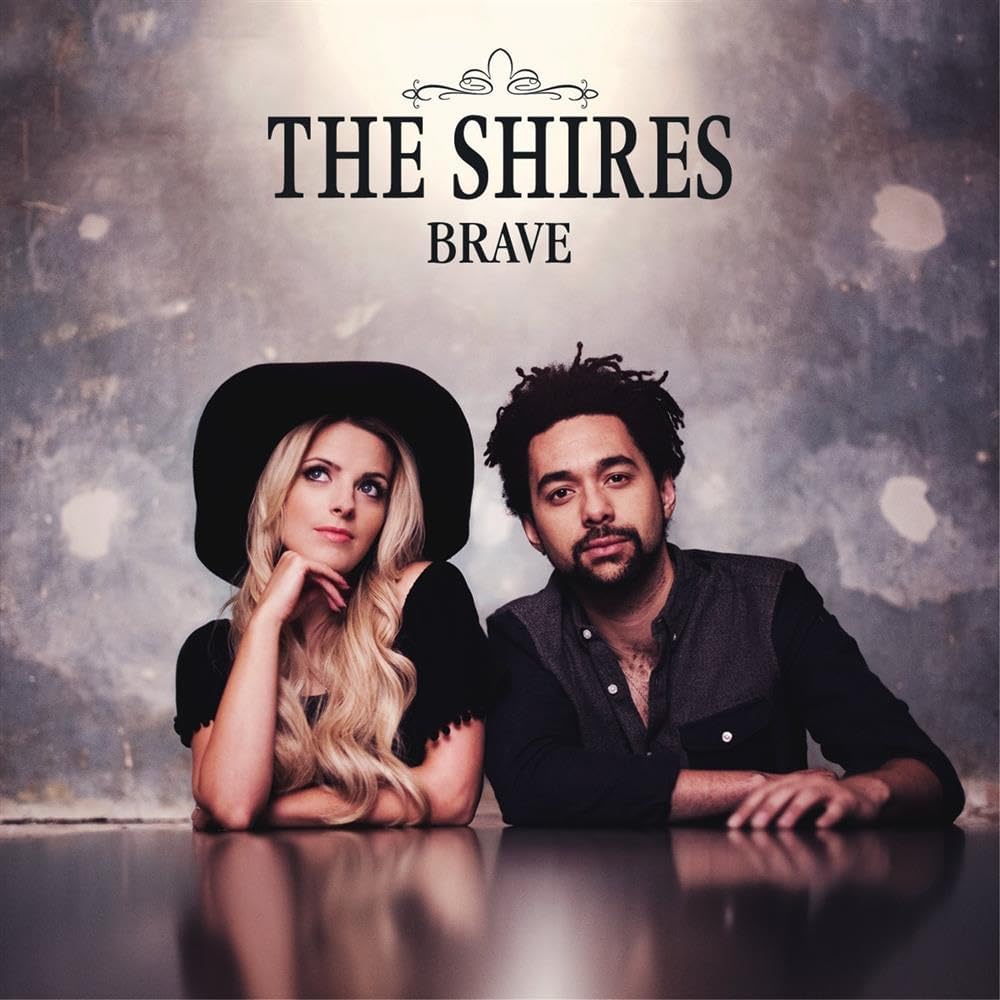 Album cover for 'Brave' by The Shires featuring a man and woman sitting together.