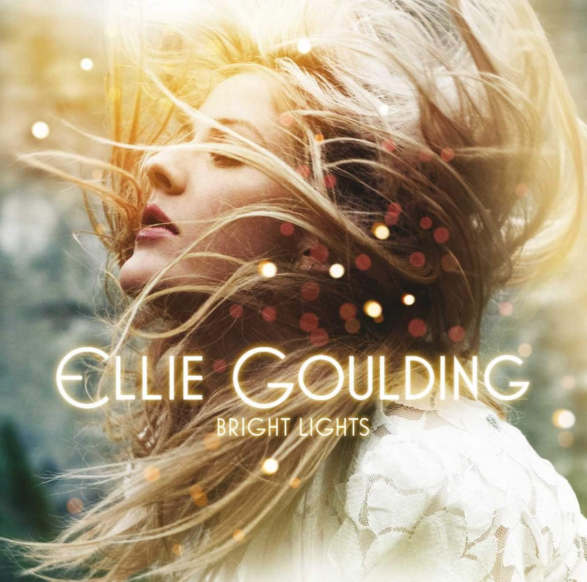 Album cover for 'Bright Lights' by Ellie Goulding with a woman with blonde hair and sparkles.