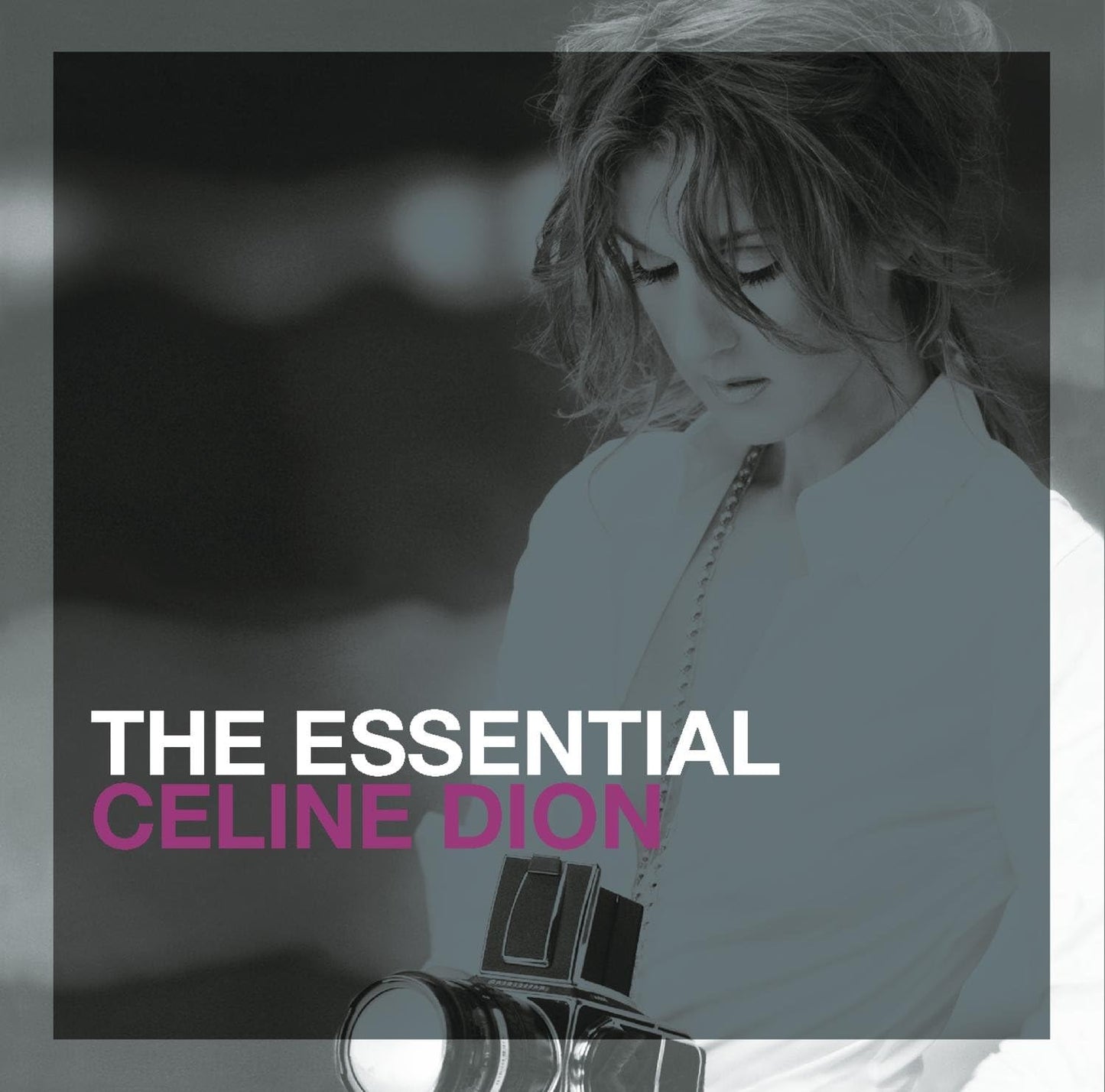 Album cover for Céline Dion The Essential 2CD with a black and white image of Céline Dion holding a camera.