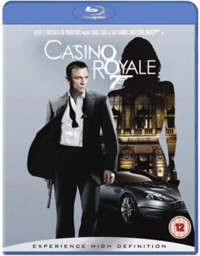 Casino Royale Blu-ray movie cover featuring a man in a black suit and white shirt holding a black jacket, with a dark car and a grand building in the background. The blue Blu-ray case border is visible, along with the title 'Casino Royale' and a 12 age rating logo.