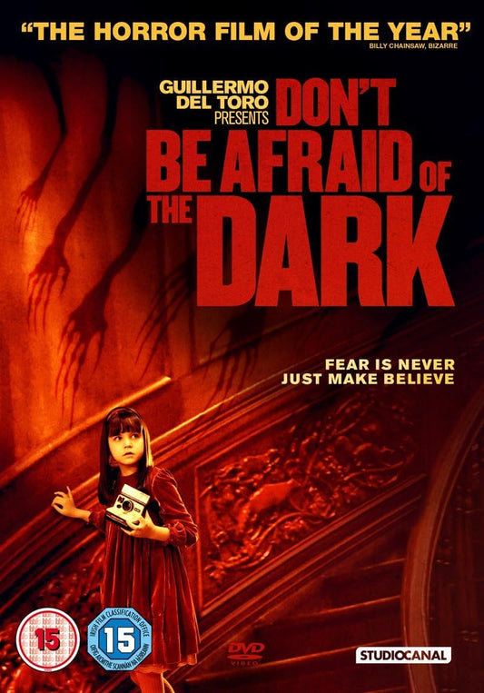 Movie poster for 'Don't Be Afraid of the Dark' with a child holding a radio and a shadowy figure.