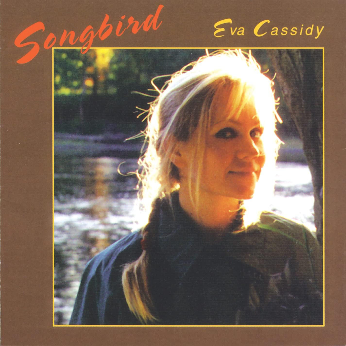 Album cover of 'Songbird' by Eva Cassidy with a blurred natural background