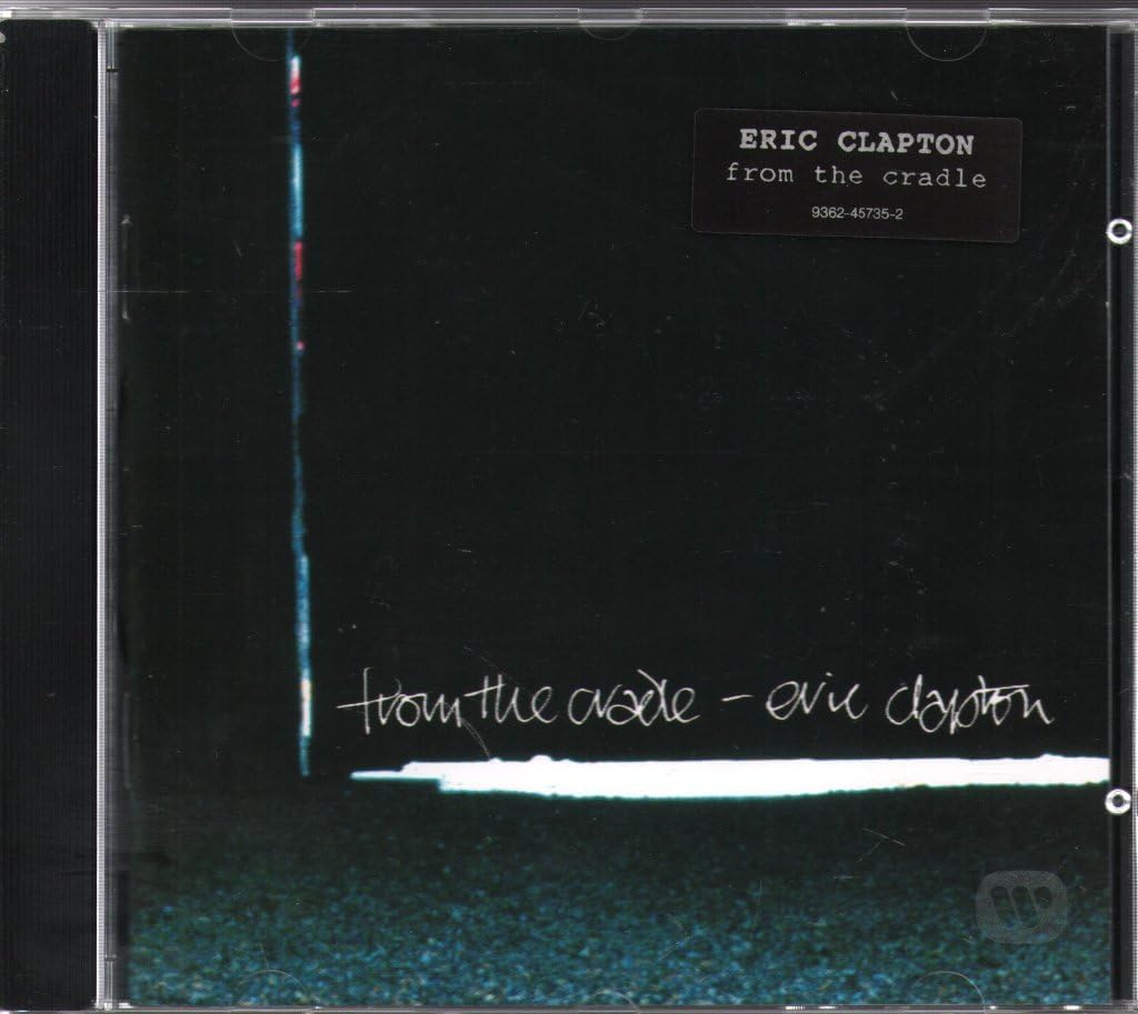 Eric Clapton 'from the cradle' CD album cover in a clear jewel case, featuring a black background with a vertical blue-white line, a white horizontal band, and white handwritten-style text.