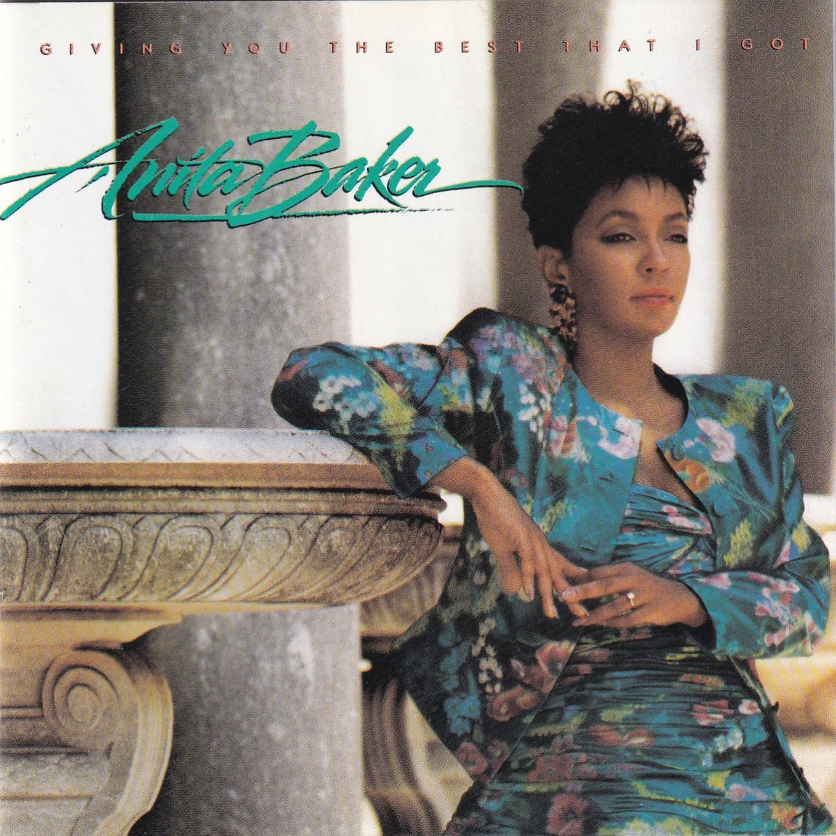 Album cover featuring a woman in a floral outfit with text 'Anita Baker' and 'Giving You the Best That I Got'.
