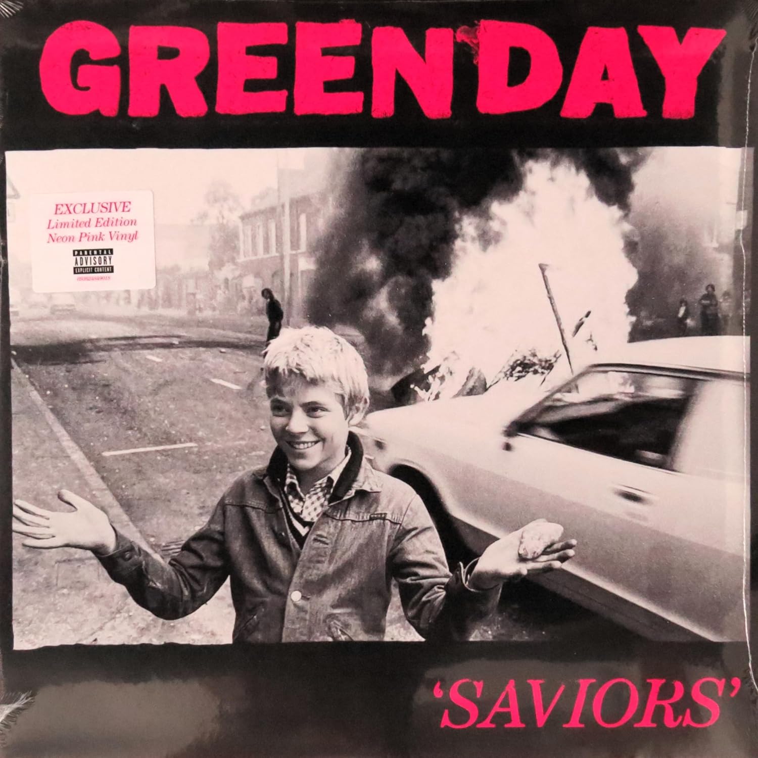 Album cover for Green Day's 'Saviors' with a black and white photo of a boy by a burning car.