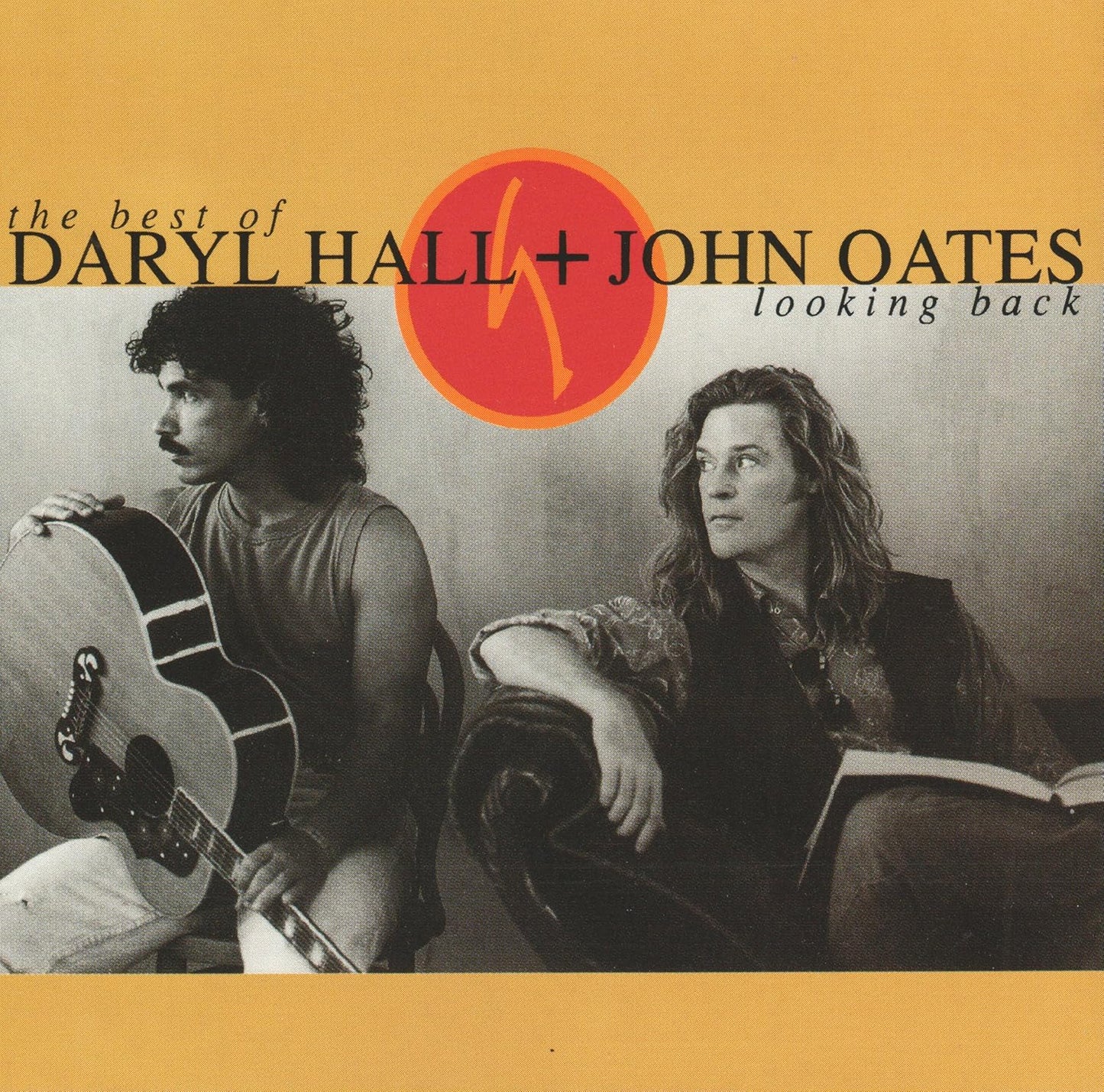Album cover featuring Daryl Hall and John Oates with a guitar and book, set against a yellow background.