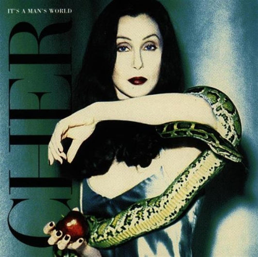 Cover of a magazine featuring a woman with a snake and an apple, titled 'It's a Man's World'.