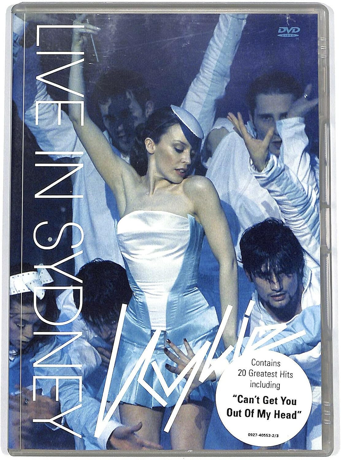Live in Sydney DVD cover featuring a woman in a white strapless dress dancing with performers in white suits under blue lighting. Large vertical text reads 'LIVE IN SYDNEY' and a white oval sticker notes it contains 20 greatest hits including 'Can't Get You Out Of My Head'.