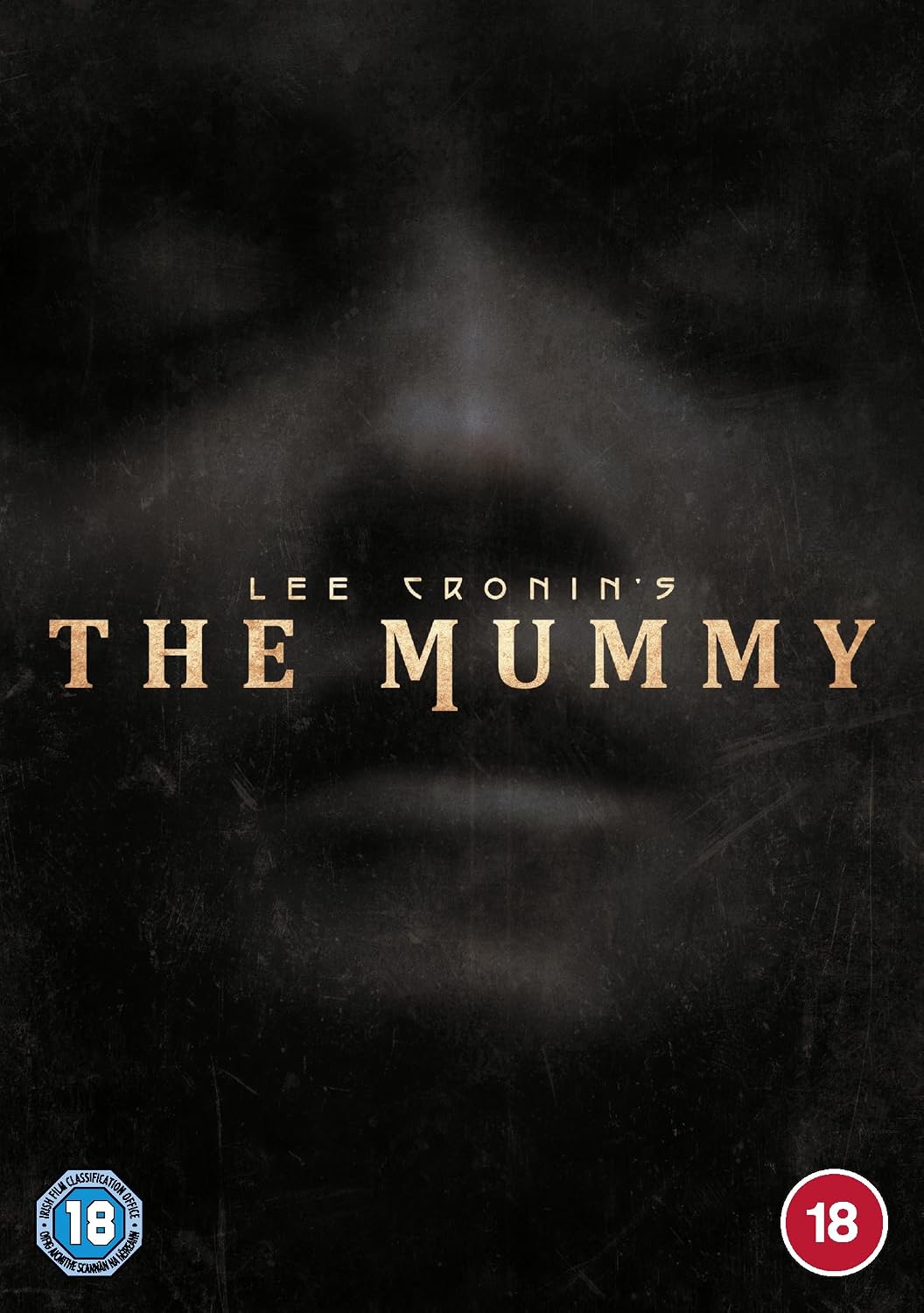 The movie cover for Lee Cronin's 'The Mummy' featuring a dark, textured background with a faint, shadowed face and the title in gold lettering. An 18 rating logo is visible in the bottom left corner, and an 18 rating circle is in the bottom right.
