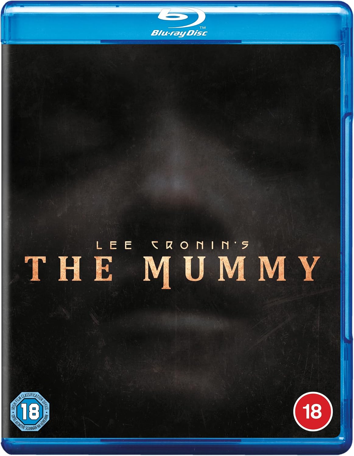 Blu-ray cover for Lee Cronin's The Mummy, featuring a dark, textured background with a faint mummy face and the title in gold lettering. The blue Blu-ray case borders are visible, along with 18 age rating badges in the bottom corners.