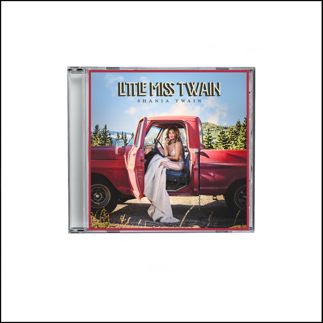 CD album cover for 'Little Miss Twain' by Shania Twain, featuring a woman sitting in the open door of a red pickup truck with a blue sky and trees in the background.