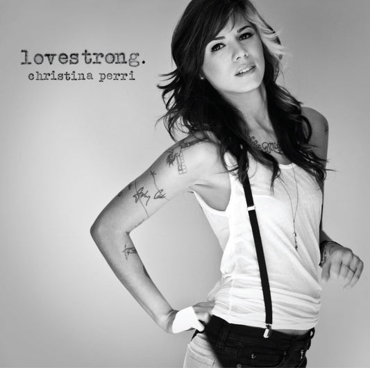 Black and white album cover with a person wearing suspenders and tattoos, featuring the text 'Lovestrong' and 'Christina Perri'.