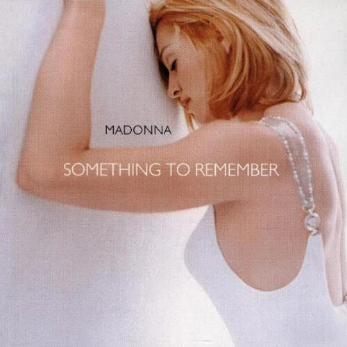 Album cover with a person in a white dress and text 'MADONNA SOMETHING TO REMEMBER' on a white background