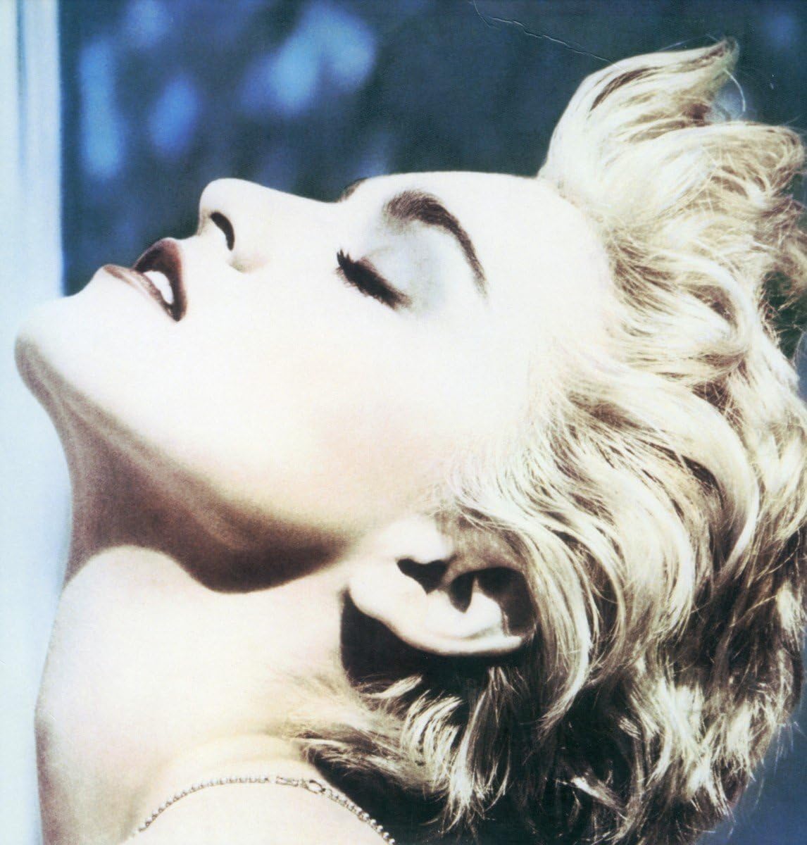 Close-up of a person with blonde hair and a blurred background