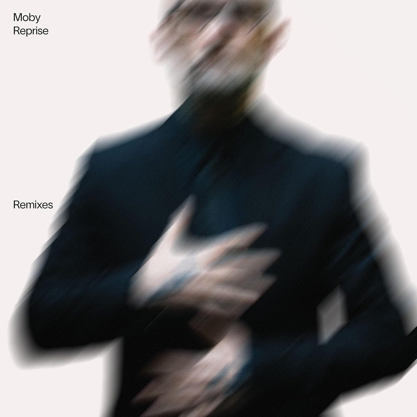 Album cover with a blurred figure and text 'Moby Reprise Remixes' on a light background