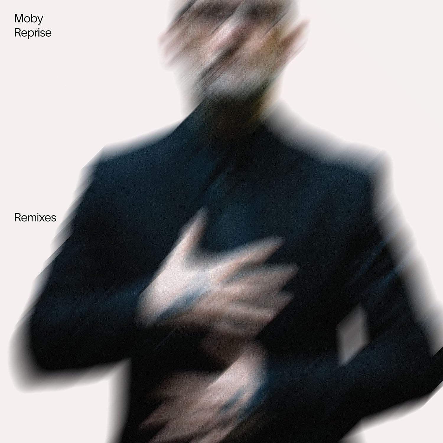 Album cover with a blurred figure and text 'Moby Reprise Remixes' on a light background
