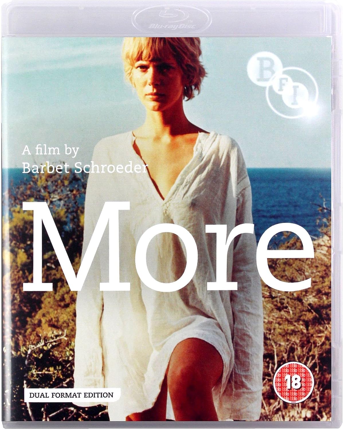 Blu-ray cover for the film 'More' by Barbet Schroeder, featuring a woman in a white dress seated outdoors with the ocean in the background. The title 'More' is printed in large white letters, with a circular 'BFI' logo and an '18' rating badge visible.