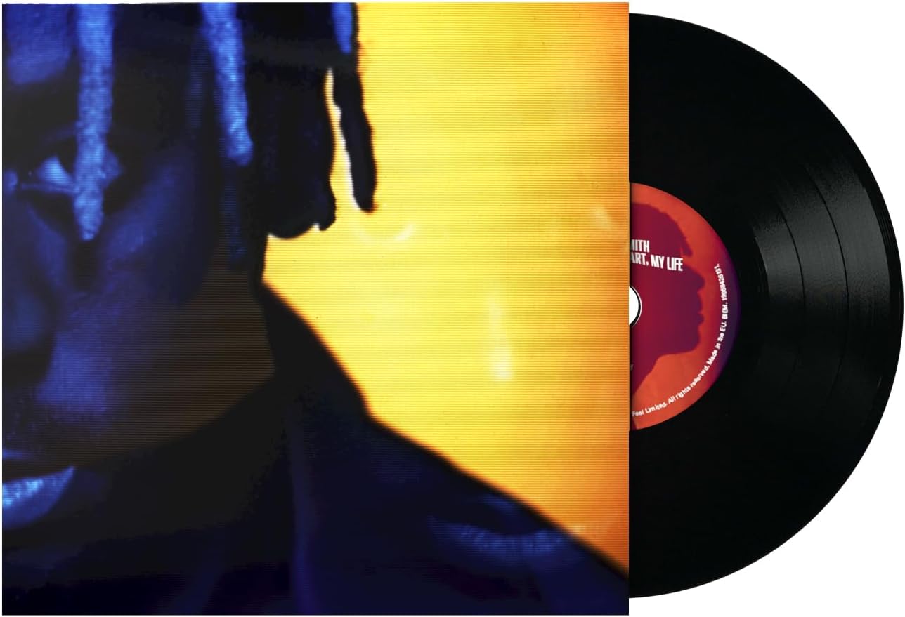 Vinyl record album shown with the sleeve partially covering the record. The cover features a close-up portrait in deep blue tones with a large bright yellow block behind the face.