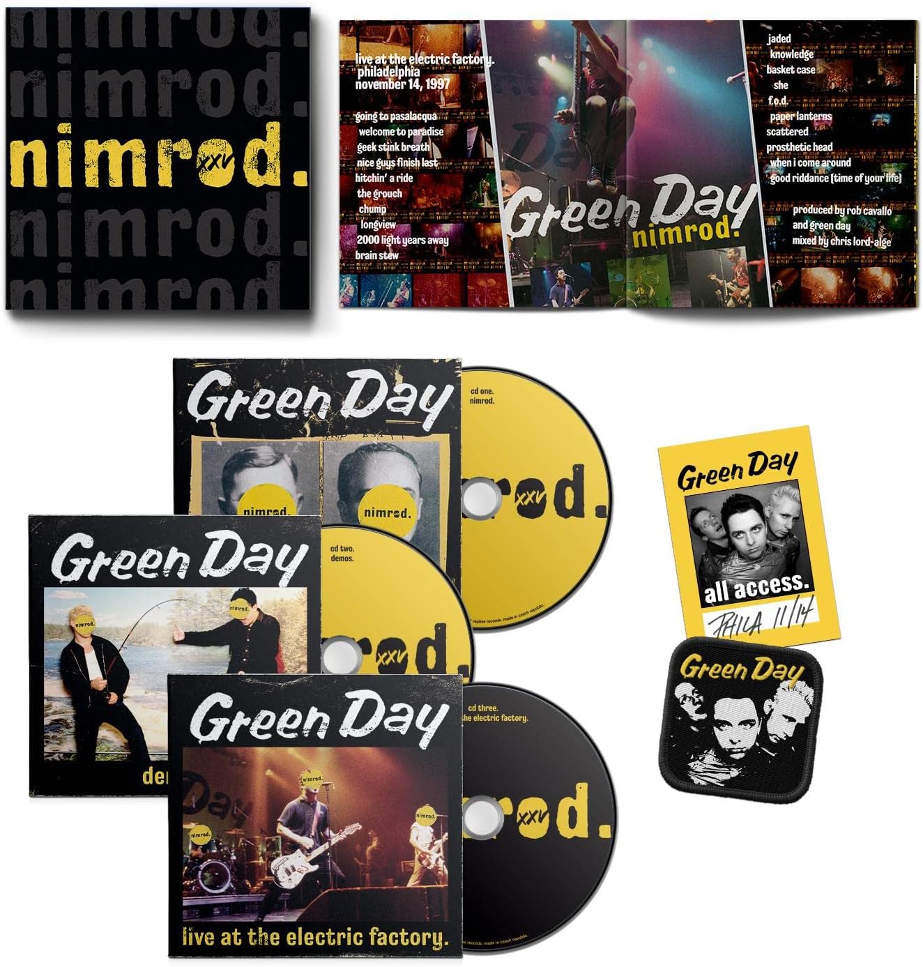 Green Day 'nimrod.' live at the electric factory 20th anniversary box set, featuring a CD, two VHS tapes, a booklet, a poster, a sticker, and a patch on a white background.