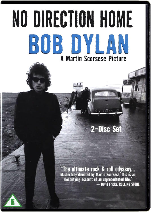 DVD cover for 'No Direction Home [Bob Dylan]' featuring a black and white image of Bob Dylan with the backdrop of a car and a signpost, indicating a documentary style setting.