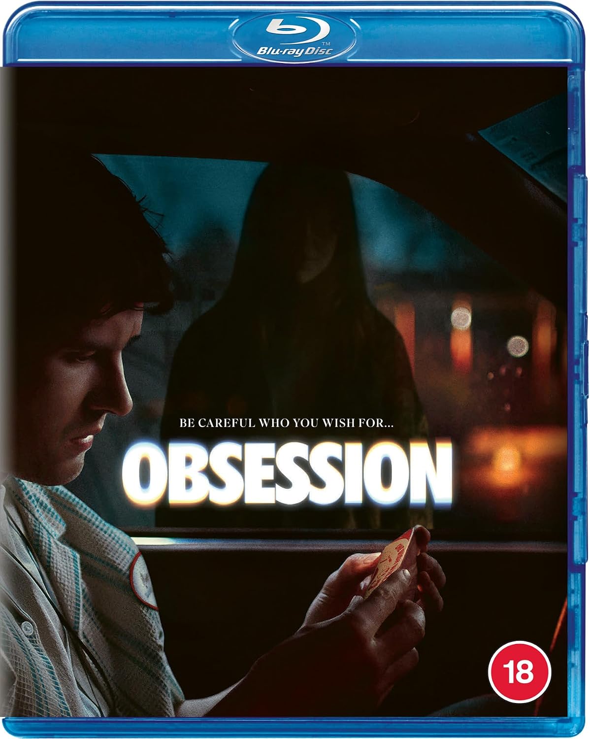 Blu-ray movie cover for the film 'Obsession' with a blue plastic case, showing a man in a car holding a phone, a dark hooded figure in the background, and the title 'OBSESSION' in large white letters.